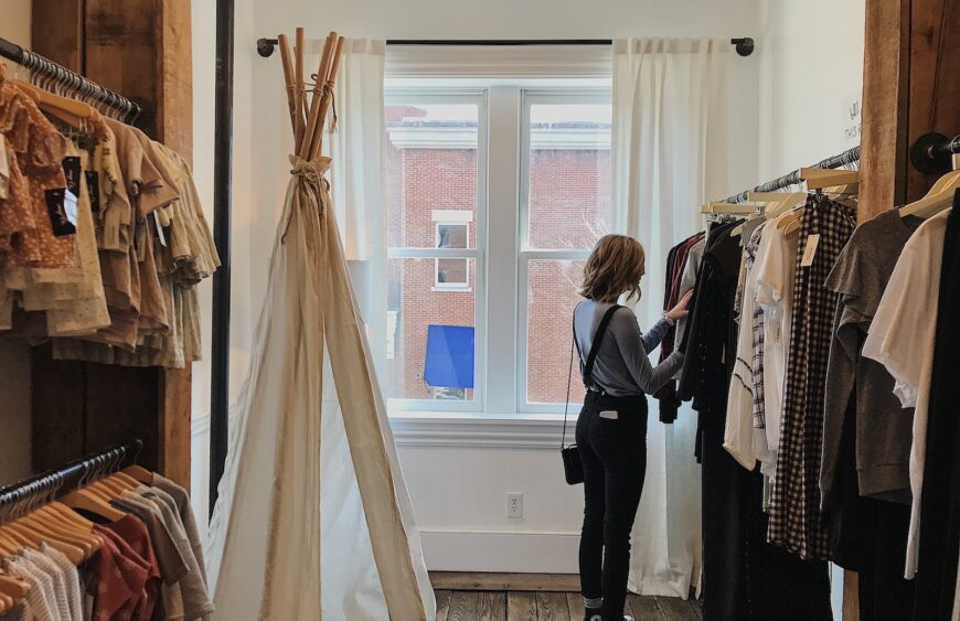 woman standing selecting clothes